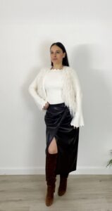 Gilet Nuvola bianco indossato con maglia smerlata bianca e gonna marrone in ecopelle.